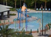 Outdoor pool area with kids' splash zone.