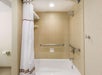 Accessible guest bathroom with grab bars.