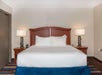 One king bed with plush pillow top mattress inside a non-smoking guest room.