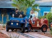 Kids with their parents riding a mini truck in Aussie Trek at ZooTampa at Lowry Park.