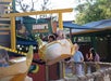 Kids trying the Boomer's Flying Bananas ride at ZooTampa at Lowry Park and their parents cheerfully watching them.