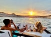 Couple taking photos of sunset during the boat tour
