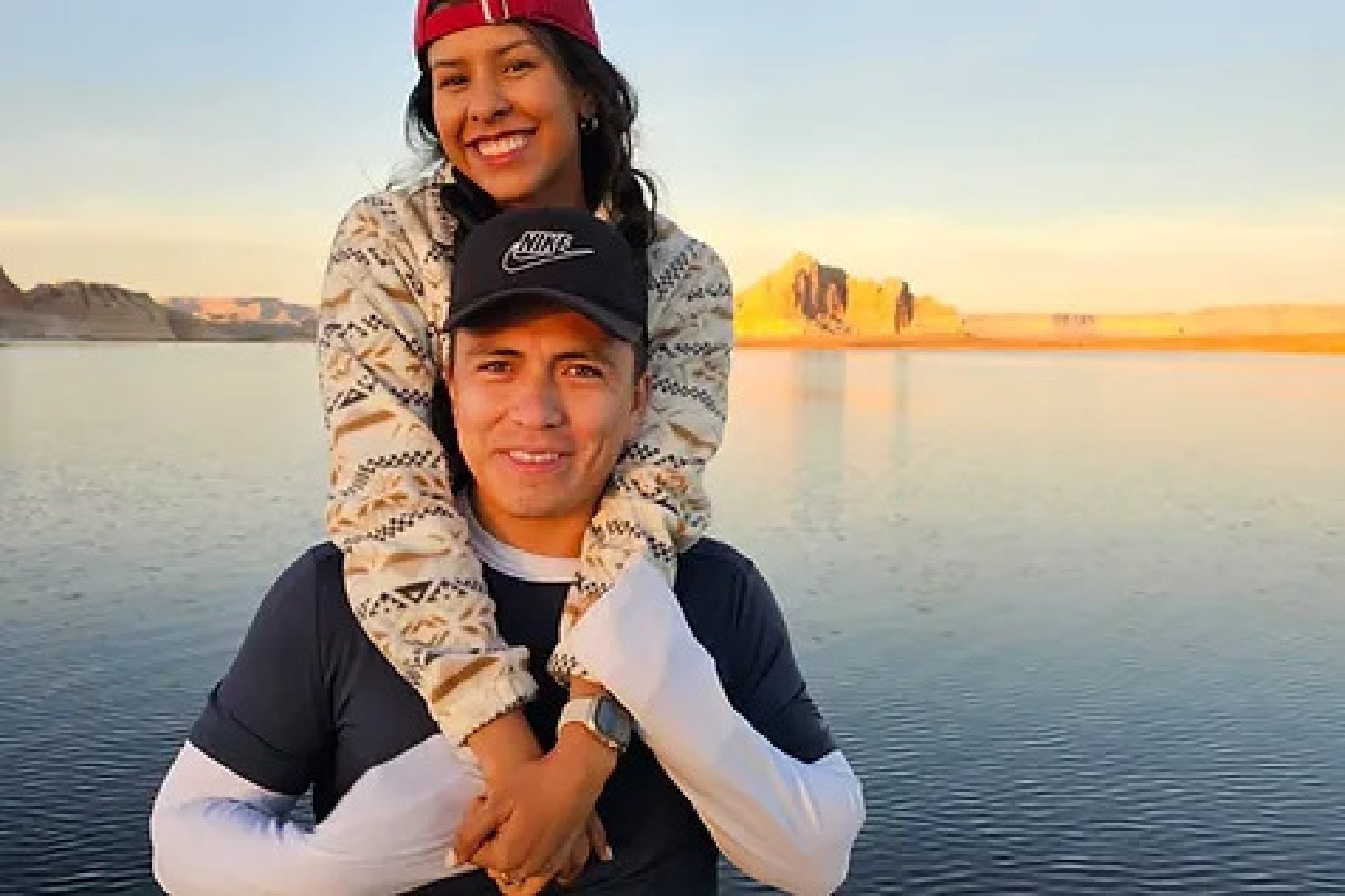 Couple taking photos with the sunset background