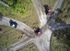 An aerial view from the sky of three guests on ATVs