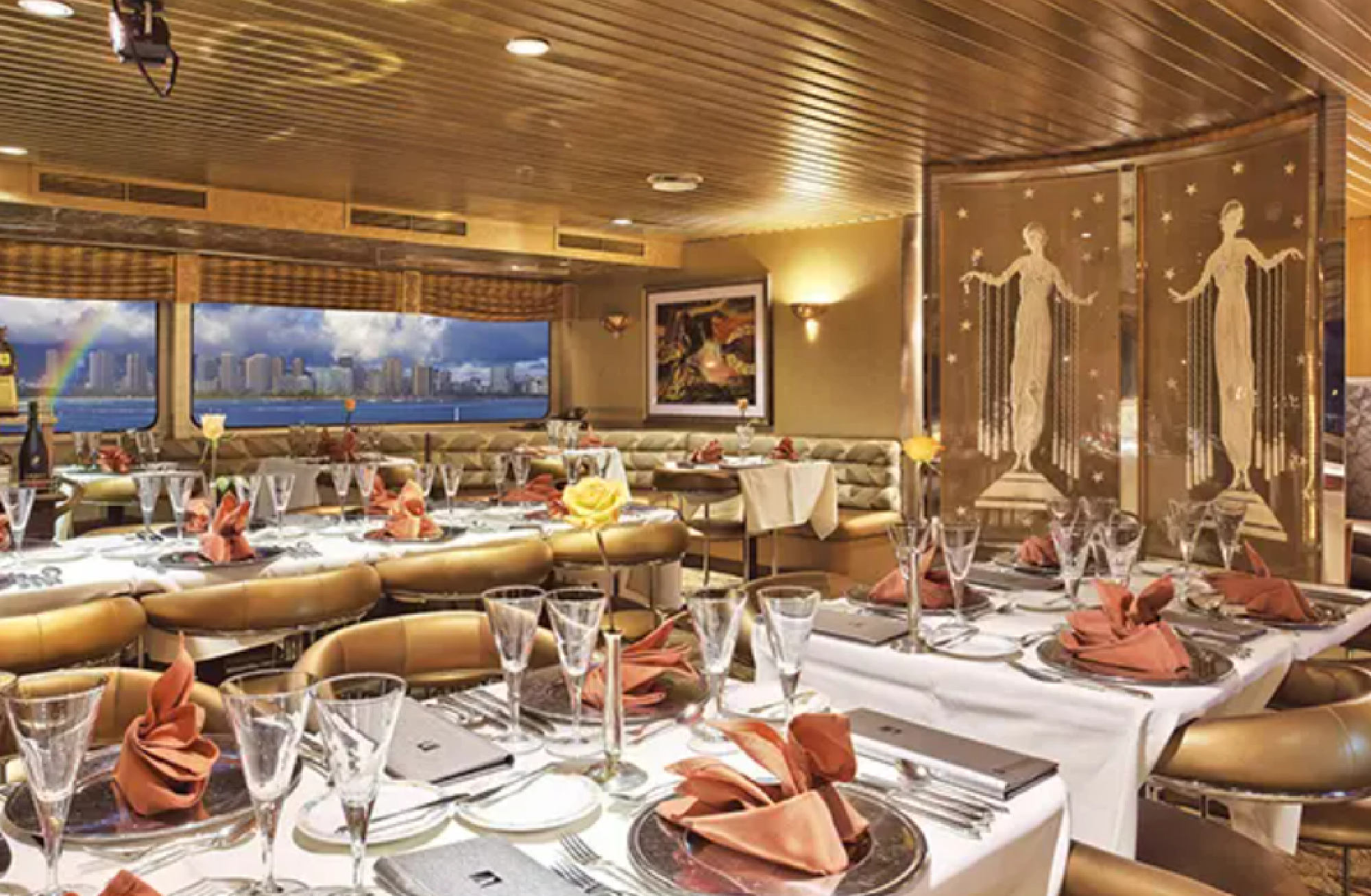 Elegant dining room with set tables, neatly folded napkins, and glasses. Large windows reveal a cityscape view. Decorative divider features artistic figures.