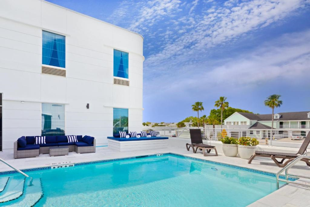 Rooftop pool with daybeds and lounge chairs