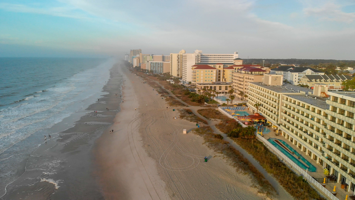 Aerial view of Myrtle Beach’s Grand Strand coastline with beachfront hotels.