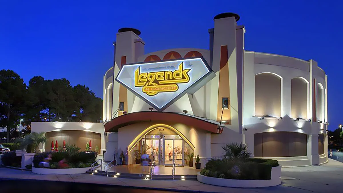 Exterior view of the Legends in Concert theater in Myrtle Beach, South Carolina, illuminated at night.