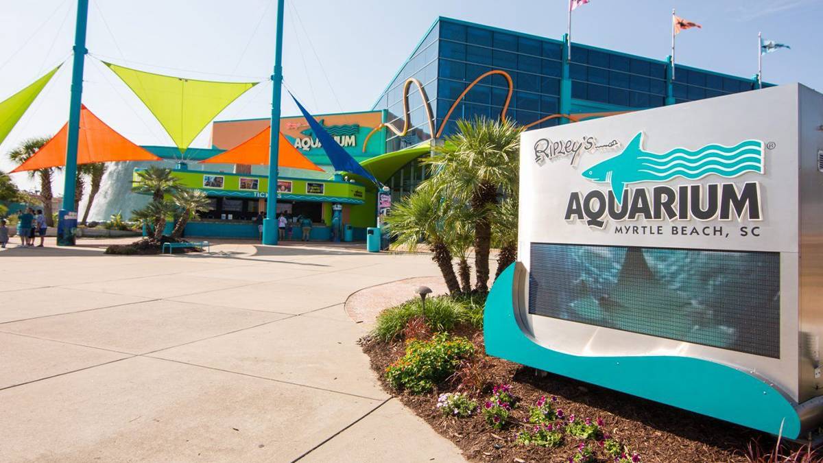 Entrance to Ripley’s Aquarium in Myrtle Beach, SC, with colorful sails and signage.