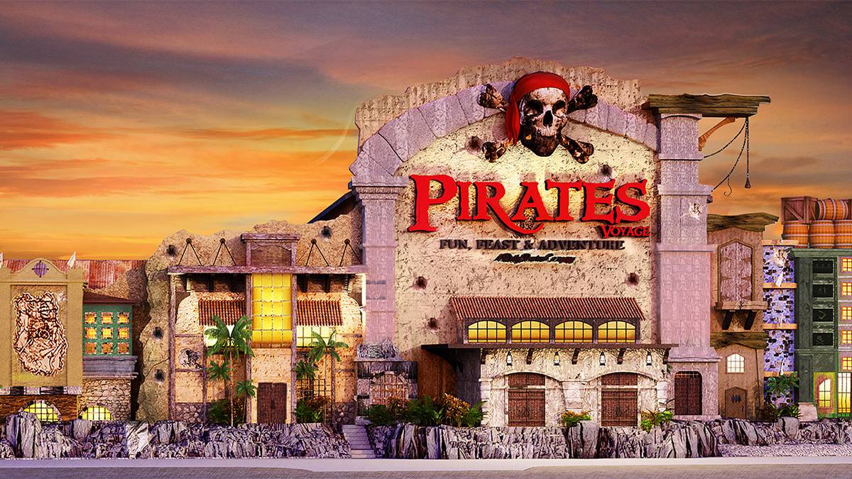 Exterior view of Pirates Voyage Dinner and Show in Pigeon Forge, Tennessee, featuring a pirate-themed building with a sunset backdrop.