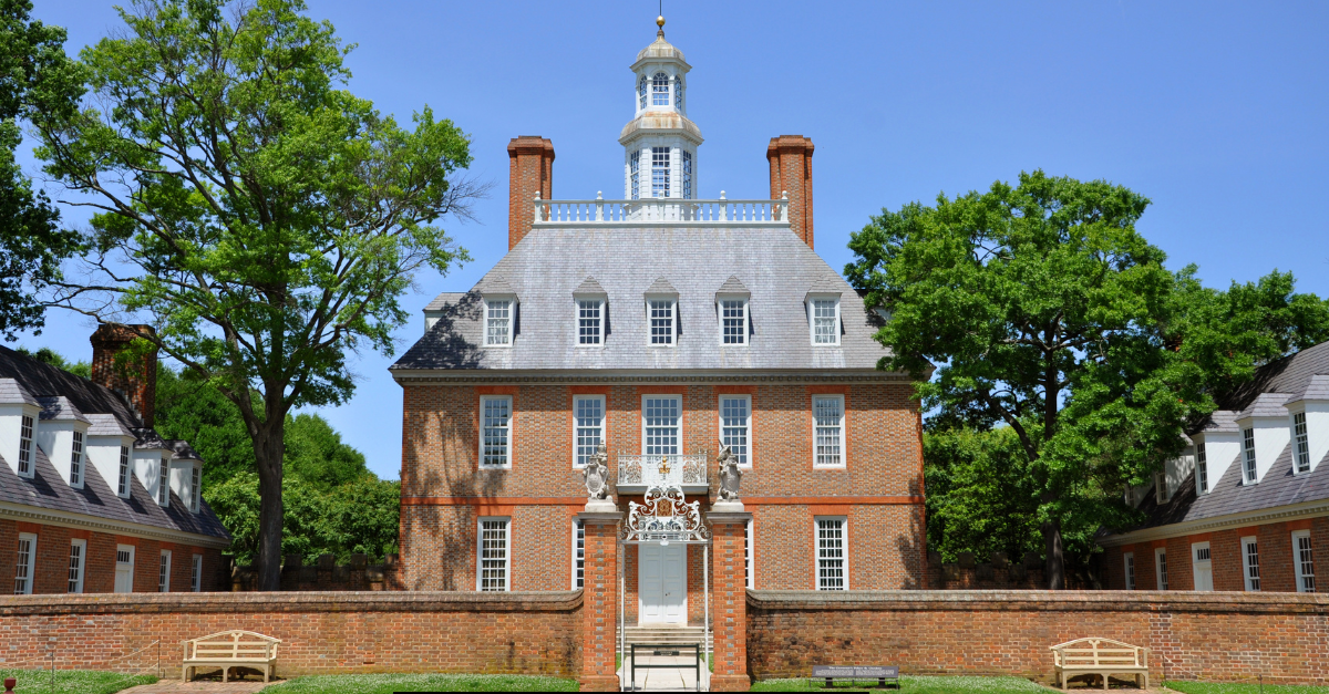 Governor’s Palace in Colonial Williamsburg, Virginia, surrounded by lush greenery and clear blue skies.