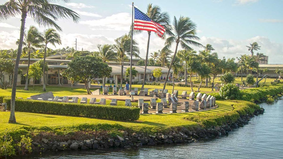 ground distant view of the entrance to Pearl Harbor with the United States flag with view of water in Oahu, Hawaii, USA