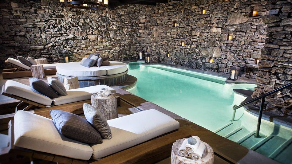 indoor spa and pool with rock wall inside of Cedar Creek Spa & Salon in Branson, Missouri, USA