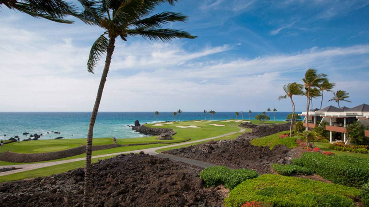 exterior ground view of Mauna Lani Point with large palm trees on The Big Island, Hawaii, USA