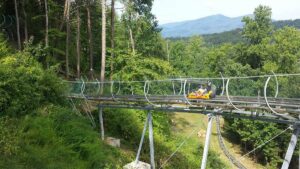 Wide shot of a person on Smoky Mountain Alpine Coaster in Pigeon Forge, Tennessee, USA