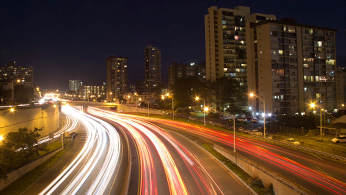 ground view of car lights at night in Honolulu, Hawaii, USA