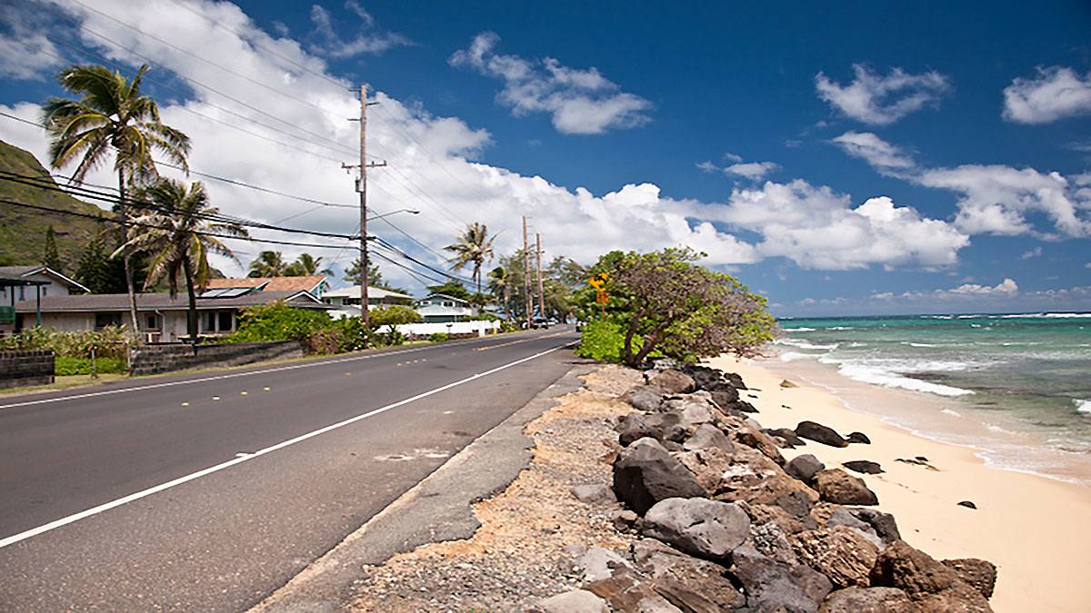ground view of street with sandy beach along the North Shore Road in Oahu, Hawaii, USA
