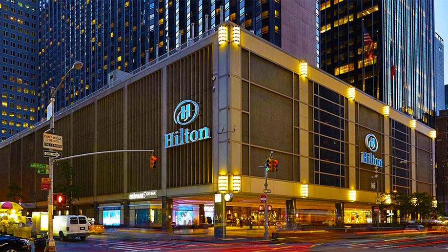 ground view of the Hilton Midtown at night with lights in NYC, New York, USA