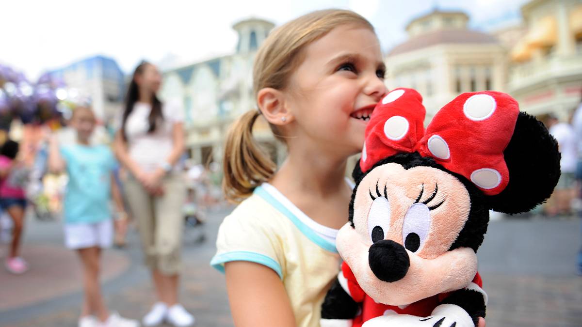 Child With Mini Doll at Walt Disney World's Magic Kingdom - Orlando, Florida, USA