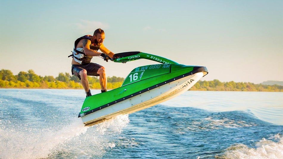 man on green boat boating on Table Rock Lake - Branson, Missouri, USA