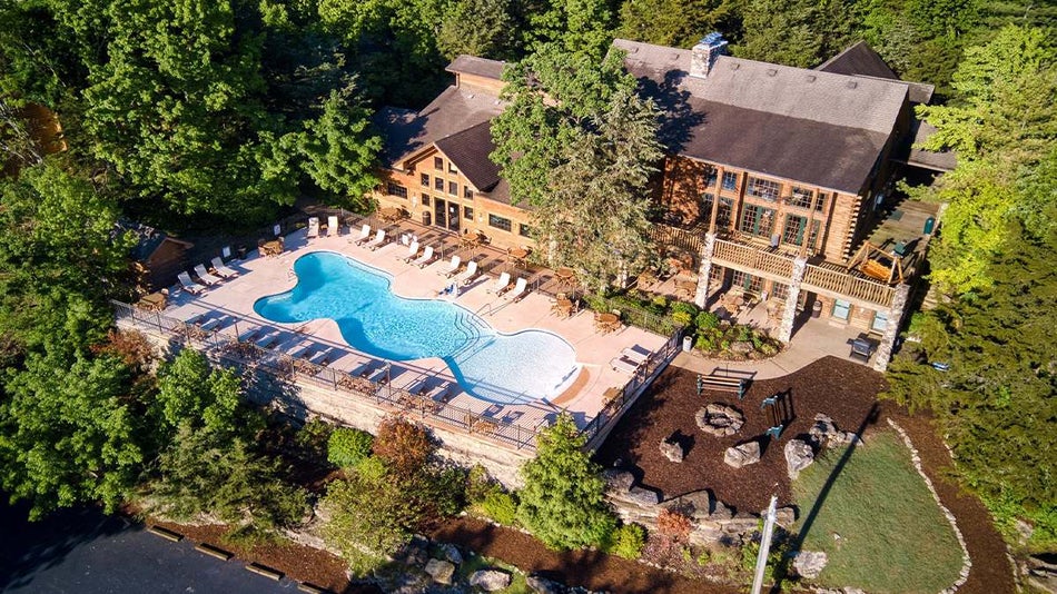Aerial view looking down at the back of Village at Indian Point Resort and their pool and fire pit area on a sunny day in Branson, Missouri, USA