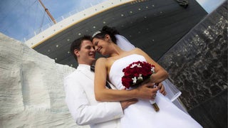 husband and wife standing in front of TITANIC Museum Attraction on their wedding day in Branson, Missouri, USA
