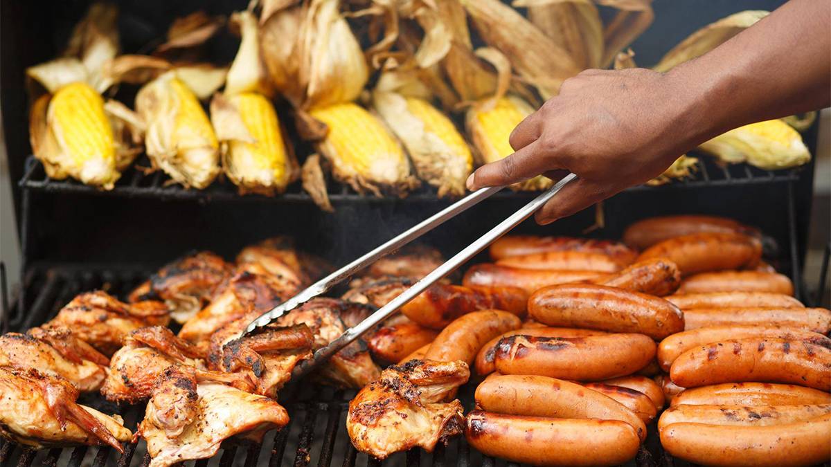 Close up of a grill full of cron, chicken, and sausages at the BBQ and Blue Grass Festival at Dollywood - Pigeon Forge, Tennessee, USA