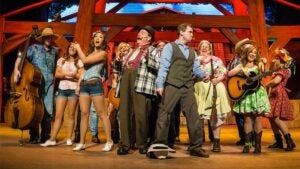 performers on stage together at the Hatfield & McCoy Dinner Show in Pigeon Forge, Tennessee, USA