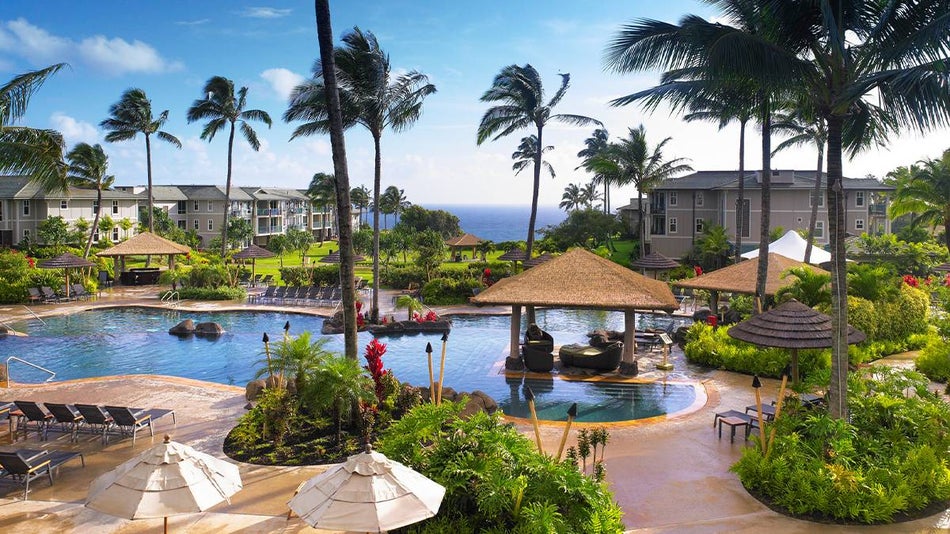 exterior view of outdoor pool and palm trees at The Westin Princeville Ocean Resort Villas in Kauai, Hawaii, USA