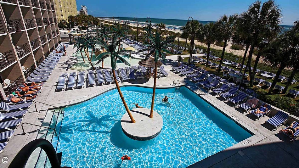 family playing in outdoor pool at Captain's Quarters Resort in Myrtle Beach, South Carolina, USA