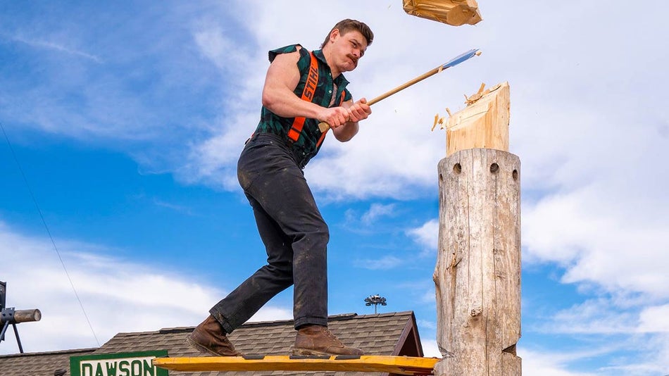 man chopping wood with an axe at Paula Deen's Lumberjack Feud Show in Pigeon Forge, Tennessee, USA
