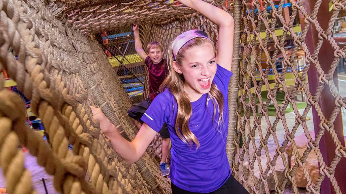 children going through obstacle course with woven rope at Fritz's Adventure in Branson, Missouri, USA
