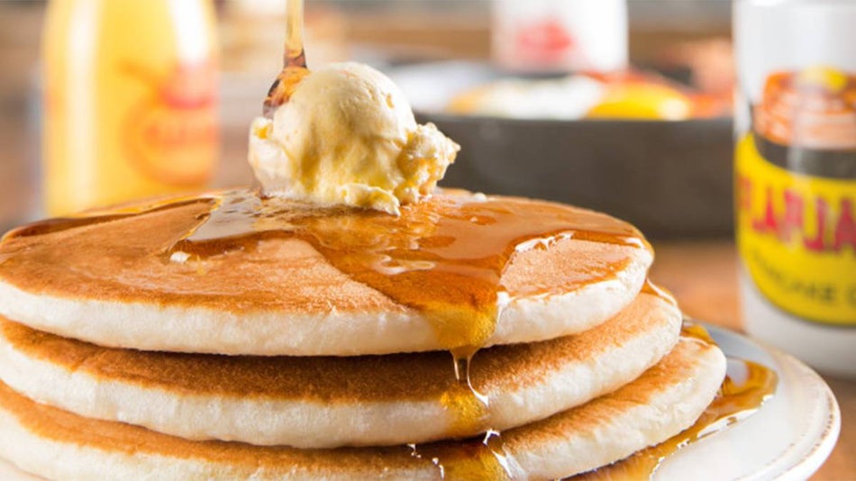 close up of stack of pancakes with syrup being poured at Flapjacks Pancake Cabin in Gatlinburg, Tennessee, USA