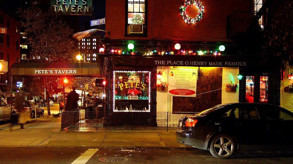 exterior street view of Pete's Tavern at night with lights in NYC, New York, USA