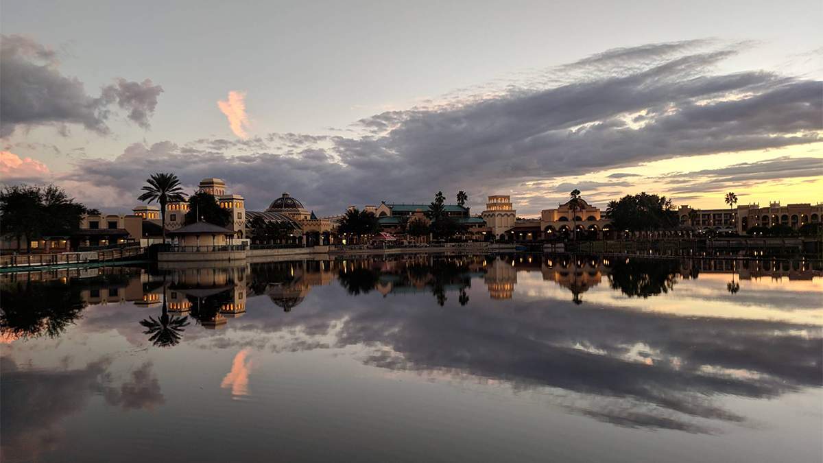 exterior dusk view of Disney's Coronado Springs Resort with reflection on the water in Orlando, Florida, USA