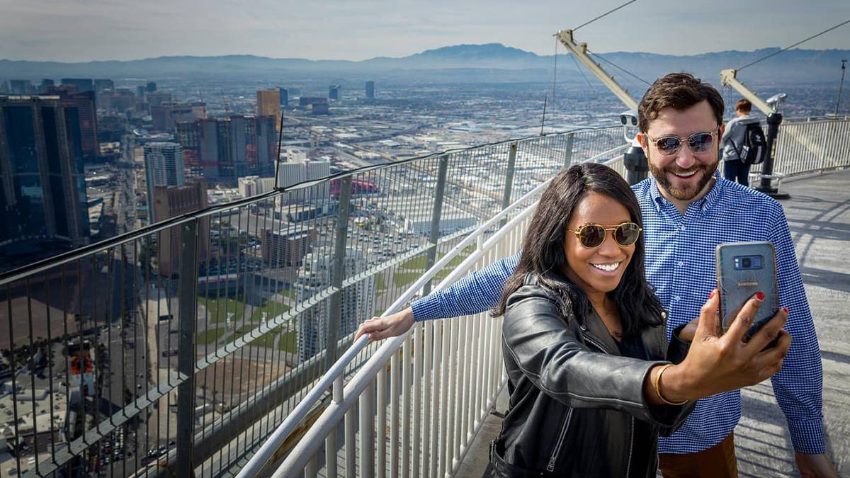 couple taking selfie together on the top of The STRAT Hotel, Casino & SkyPod in Las Vegas, Nevada, USA