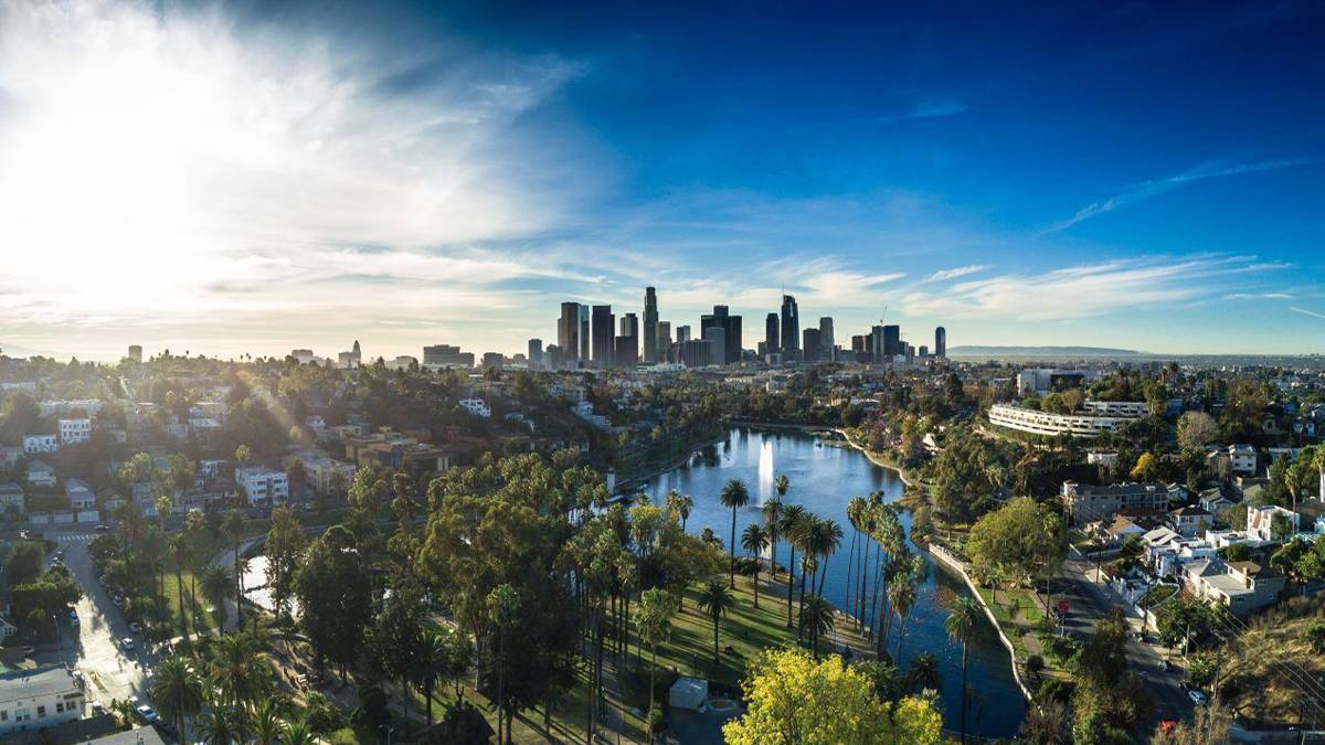 aerial drone view of the downtown skyline of Los Angeles, California, USA with sunset in the background