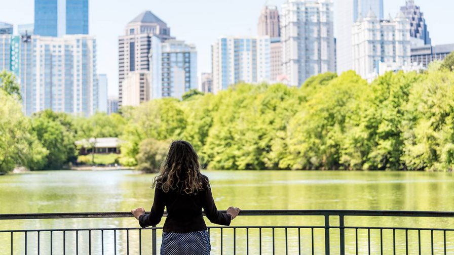 woman standing at railing at Piedmont Park in Atlanta, Georgia, USA