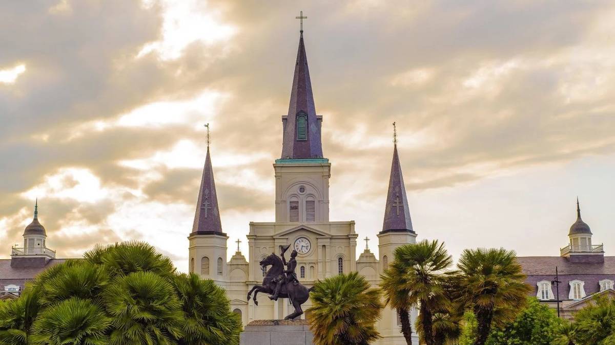 exterior view of St Louis Cathedral with the sunset in the background in New Orleans, Louisanna, USA