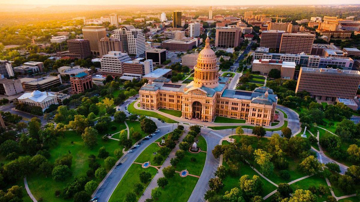 aerial view of austin texas state capitol at sunset with orange and yellow hues