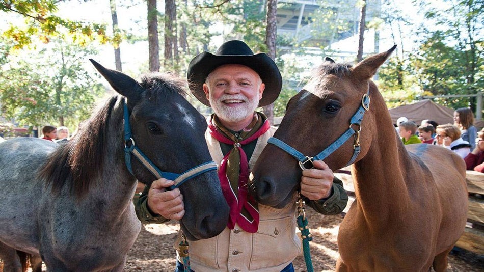 Man with two horses at Silver Dollar City's National Harvest & Cowboy Festival
