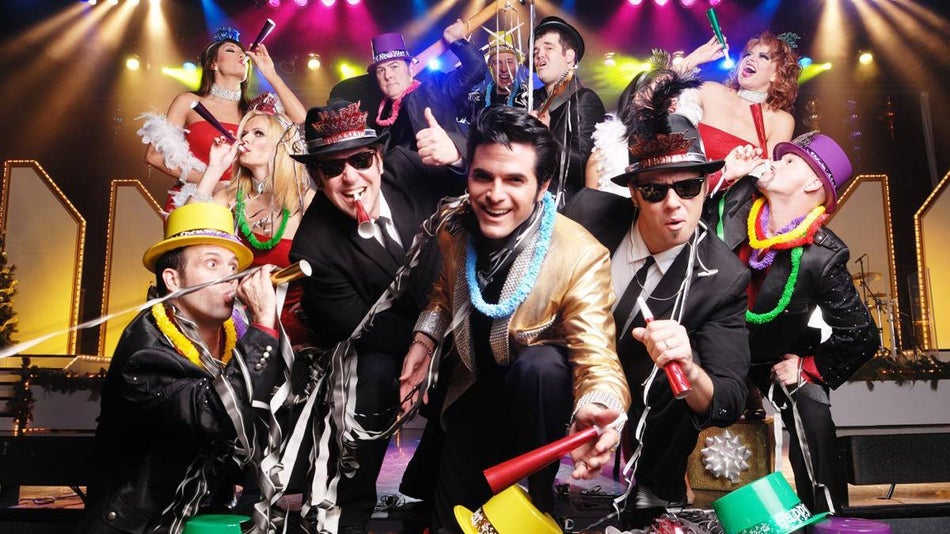 performers on stage with legends in concert with new years eve hats and noise makers in Branson, Missouri, USA