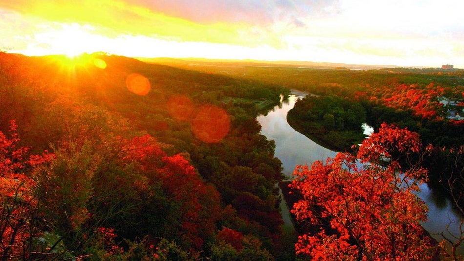 orange red sunset over autumn and fall leaves in the Ozark Mountains in Branson, Missouri, USA