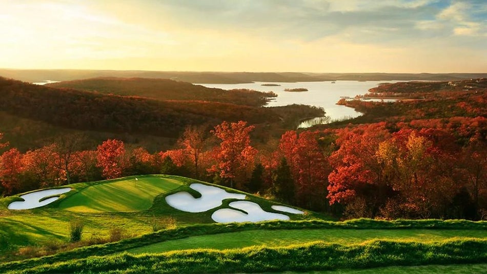 view overlooking the Top of the Rock Golf Course and orange fall autumn tree foliage in with Tablerock Lake in the background in the Ozark Mountains in Branson, Missouri, USA