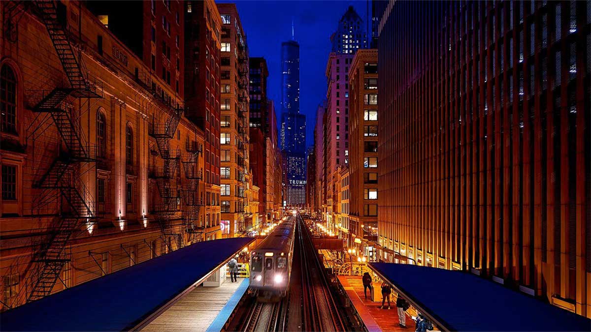 night view of downtown with L Train station in Chicago, Illinois, USA