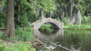 stone bridge over water surrounded by mossy trees in City Park in New Orleans, Louisanna, USA