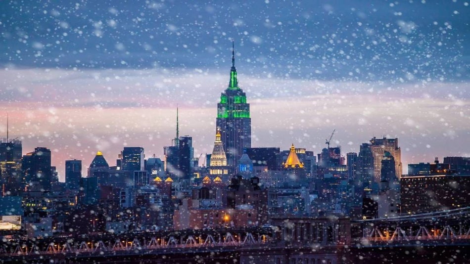 snow falling in NYC with Empire State Building in background
