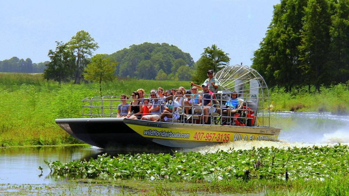 group of people on air boat in wild florida