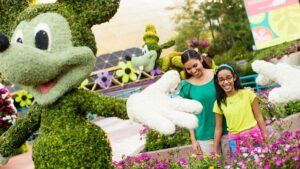mother and daughter looking at flowers and sculptures at Epcot International Flower & Garden Festival in Orlando, Florida, USA
