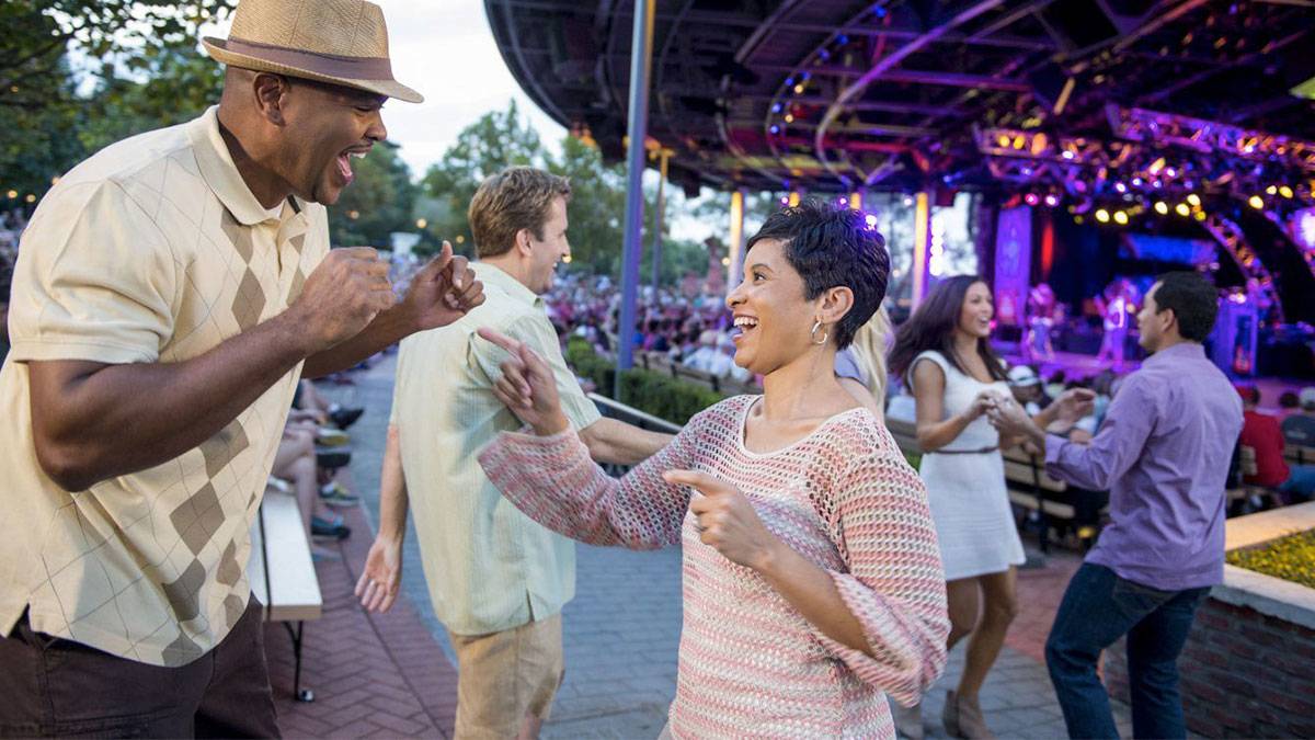 couples are dancing outdoors to live bands at Epcot International Food & Wine Festival Eat to the Beat in Walt Disney World in Orlando, Florida, USA